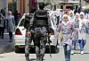 Hamas security officers secure the main street while girls talk toward their school during the press conference of the U.N. Secretary-General Antonio Guterres, at the U.N. Aleppo Elementary school in Beit Lahiya, Gaza Strip, Wednesday, Aug. 30, 2017. Gaza's Islamic Hamas rulers welcomed U.N. Secretary-General Antonio Guterres to the isolated territory Wednesday by demanding he work to lift the Israeli-Egyptian blockade of the strip and save it from a humanitarian crisis. (AP Photo/Adel Hana)