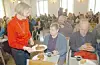 Volontär Kerstin Woodcook på Stadsmissionen serverar kaffe i Bullkyrkan.