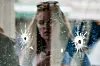 FILE- In this May 24, 2014, file photo, a woman looks at the bullet holes on the window of IV Deli Mark where a mass shooting took place near the University of California, Santa Barbara campus, in the Isla Vista beach community. In response to the killing rampage of Elliot Rodger, 22, that left seven people, including himself dead, lawmakers approved and California Gov. Jerry Brown signed a law which requires law enforcement agencies to develop policies that encourage officers to search the state's database of gun purchases as part of routine welfare checks. More than 900 laws approved by the Legislature and signed by the governor will take effect Jan. 1, 2015. (AP Photo/Jae C. Hong, File)