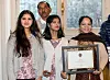 Asia Bibi a Pakistani Christian woman, right, poses with her diploma as a Citizen of Honor of the city of Paris and her daughters Eisham, 2nd right, Eisha, left, and her husband Ashik at the City Hall in Paris, Tuesday, Feb. 25, 2020. Asia Bibi a christian woman acquitted of blasphemy after spending eight years on death row in Pakistan, said she is going to request asylum in France. (AP Photo/Michel Euler) MEU103